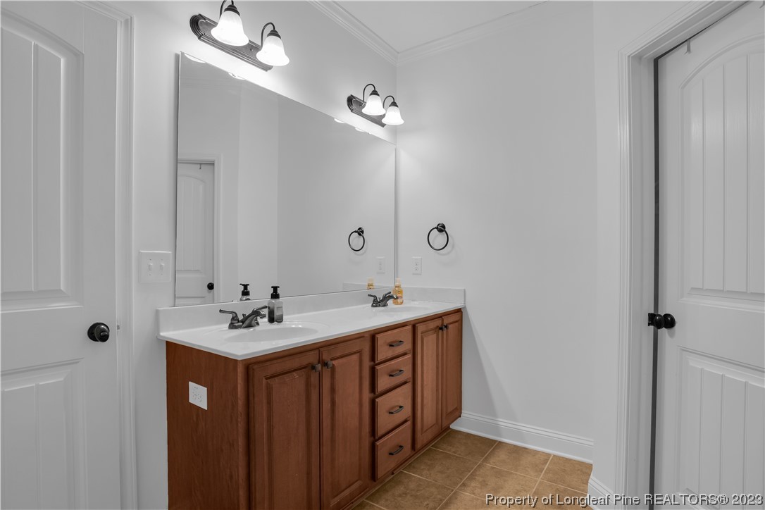 80 Valor Circle Bunnlevel, NC 28323 - Photo 28 of 49 a bathroom with 2 sink and a mirror