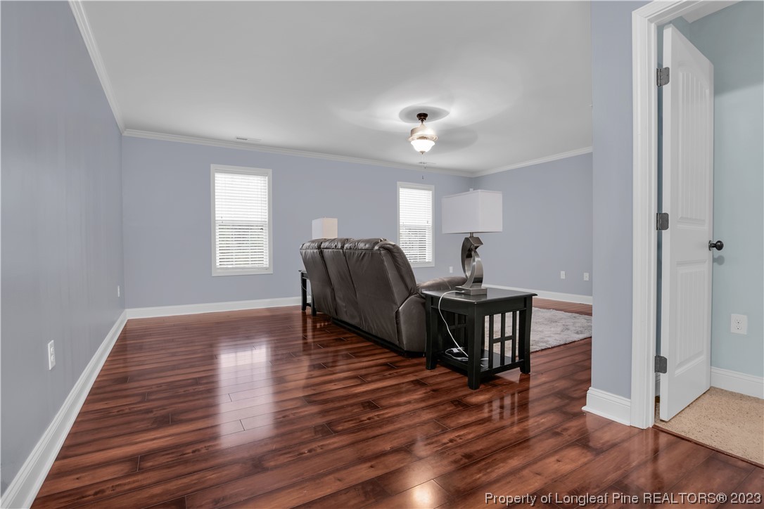80 Valor Circle Bunnlevel, NC 28323 - Photo 30 of 49 a living room with furniture and a wooden floor