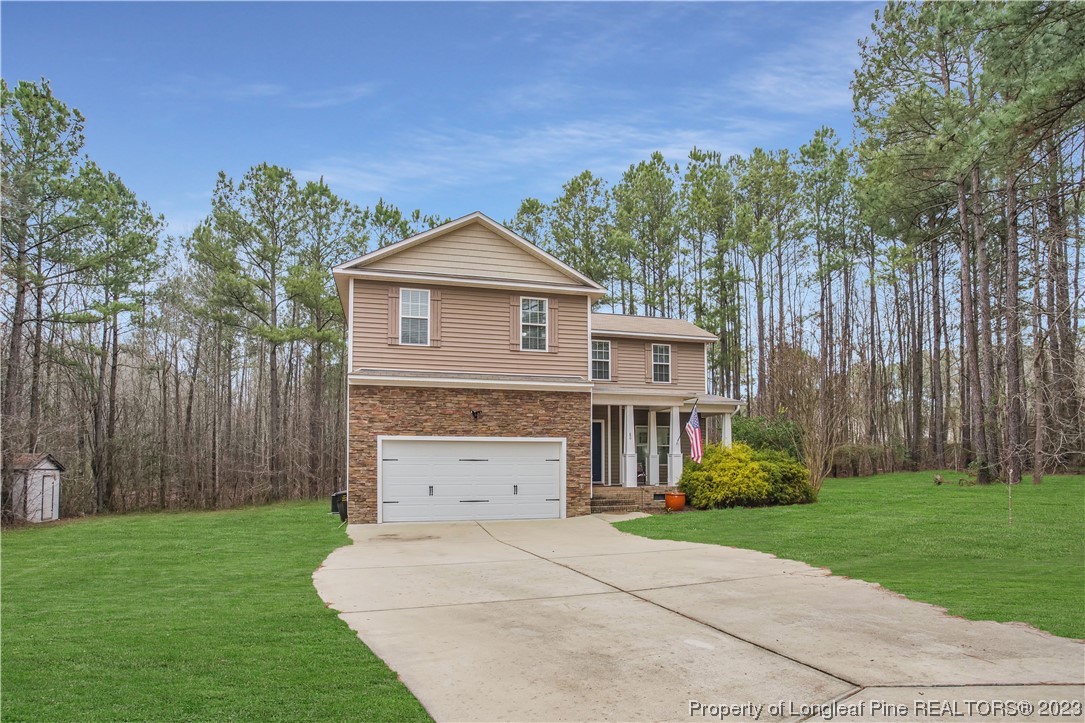 80 Valor Circle Bunnlevel, NC 28323 - Photo 3 of 49 a front view of a house with garden