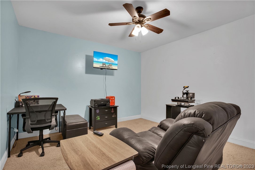 80 Valor Circle Bunnlevel, NC 28323 - Photo 35 of 49 a living room with furniture a rug and a ceiling fan