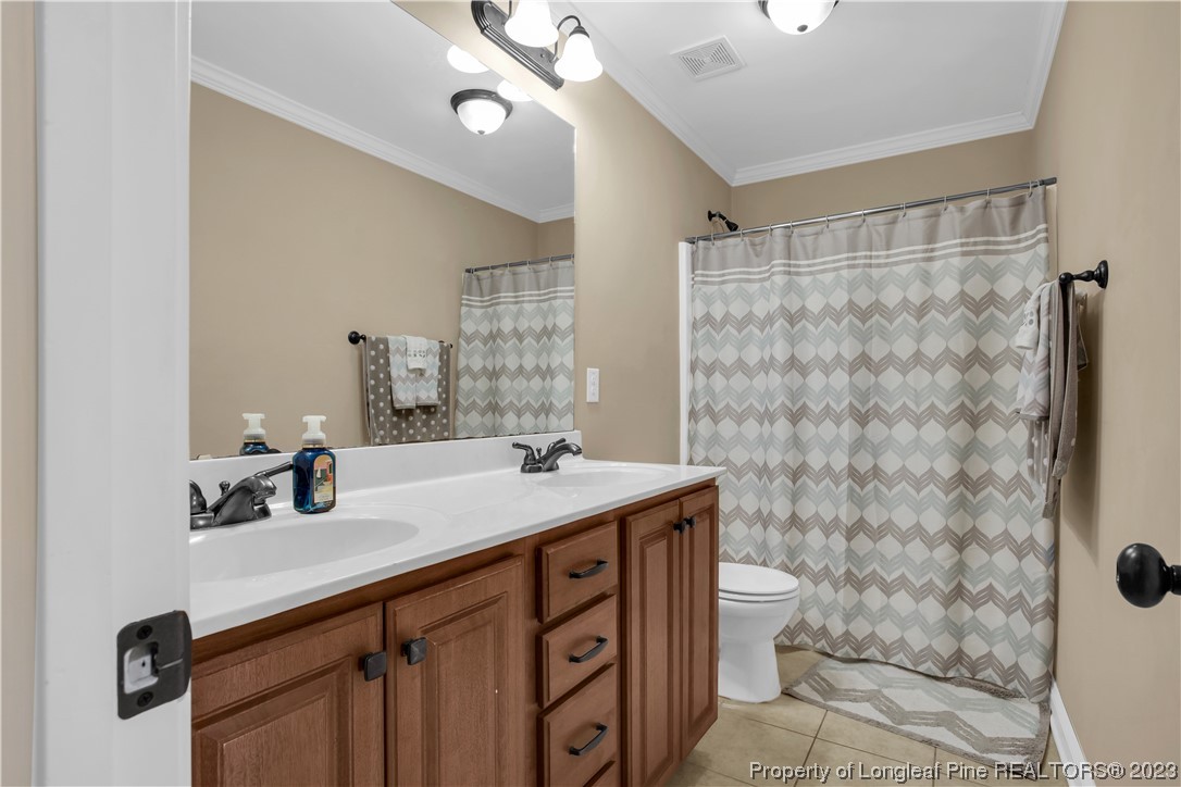 80 Valor Circle Bunnlevel, NC 28323 - Photo 37 of 49 a bathroom with a sink a toilet a mirror and shower