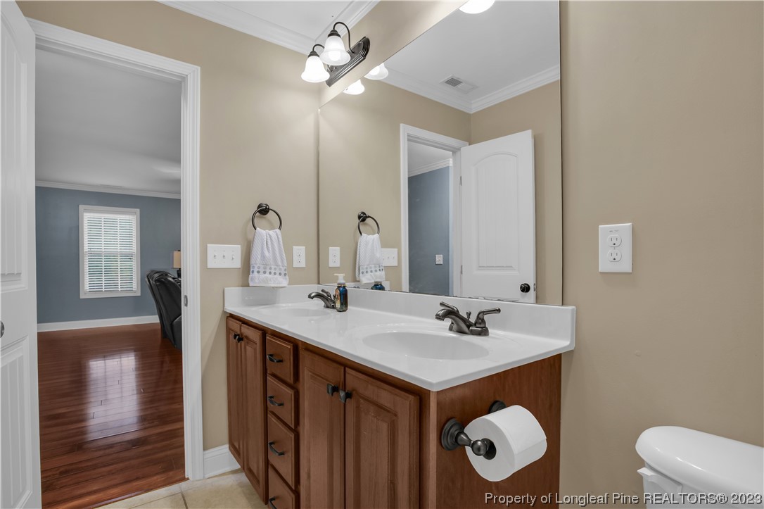 80 Valor Circle Bunnlevel, NC 28323 - Photo 39 of 49 a bathroom with a double vanity sink and a mirror