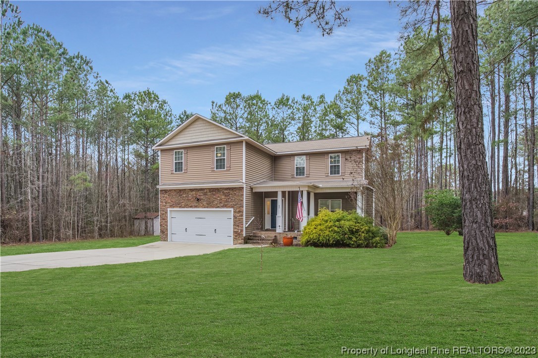 80 Valor Circle Bunnlevel, NC 28323 - Photo 4 of 49 a front view of a house with garden
