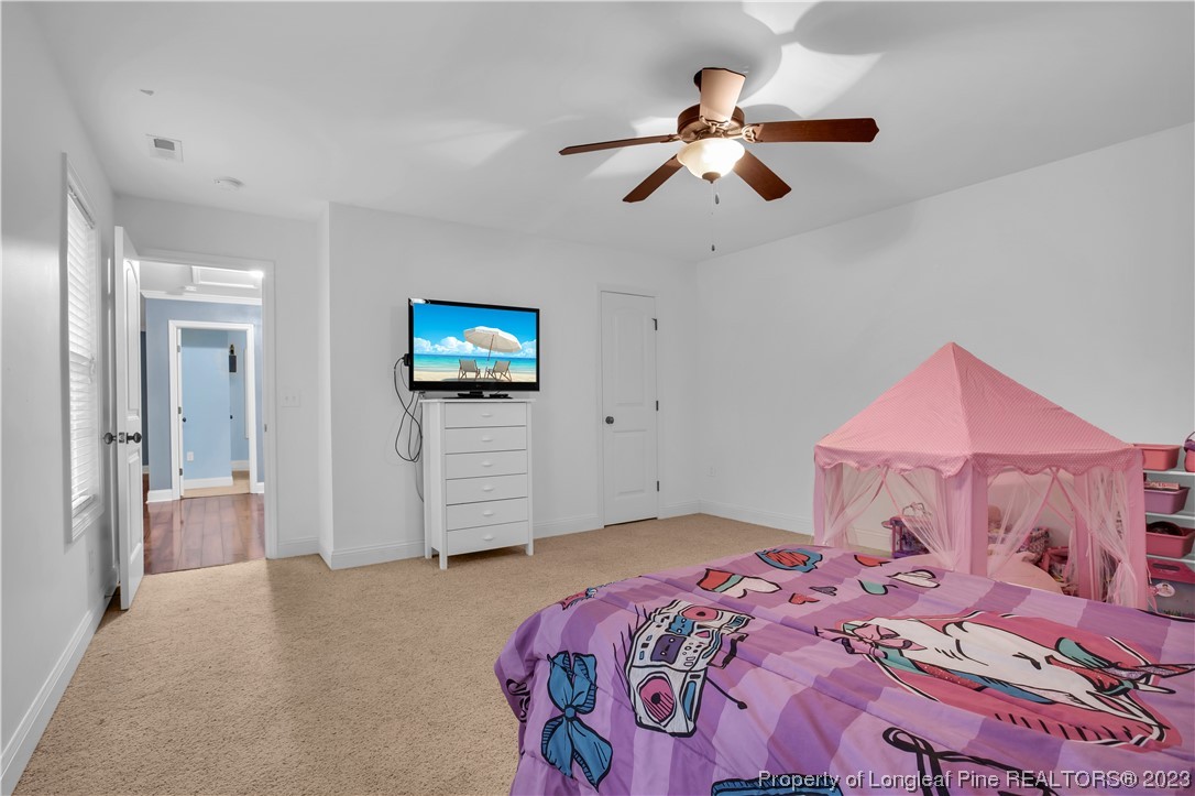 80 Valor Circle Bunnlevel, NC 28323 - Photo 41 of 49 a bedroom with a bed and a flat screen tv