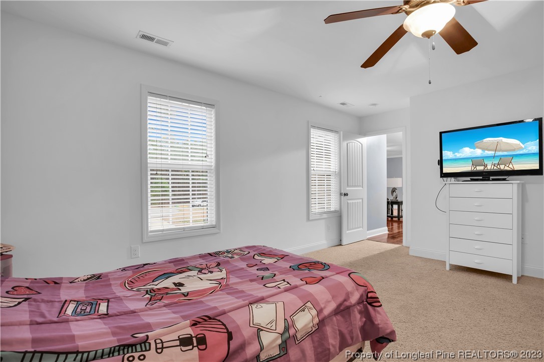 80 Valor Circle Bunnlevel, NC 28323 - Photo 43 of 49 a bedroom with a bed and a flat screen tv