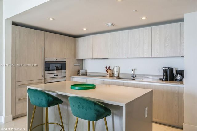 a kitchen with a stove a sink and a refrigerator