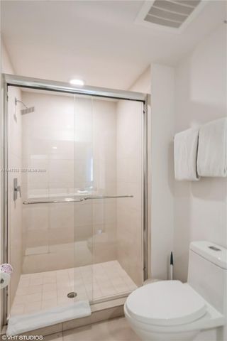 a bathroom with a shower and a toilet