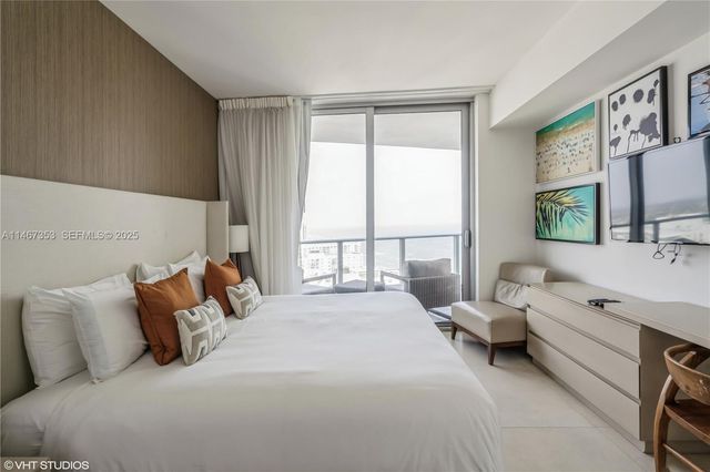 a bed room with a bed and a large window