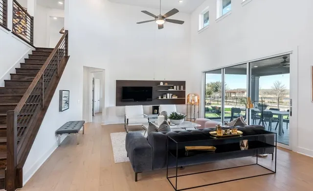 a living room with furniture kitchen view and a potted plant