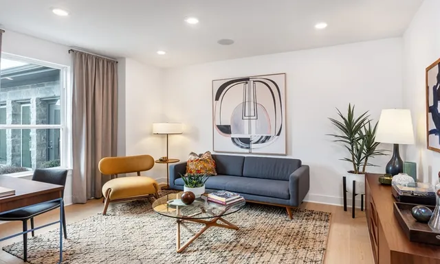 a living room with furniture and kitchen view