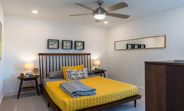 a living room with furniture and a potted plant