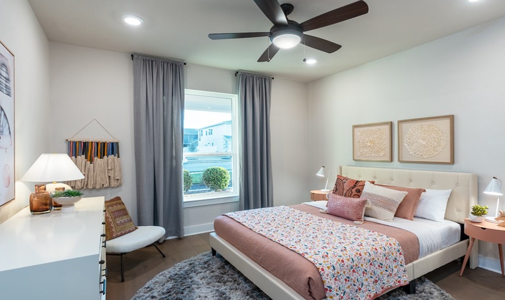 8608 Turaco Trail Austin, TX 78744 - Photo 14 of 20 a bedroom with a bed couch and window