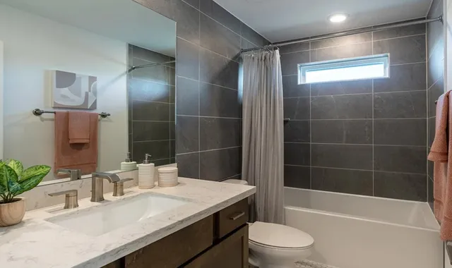 a bedroom with a bed and lamp