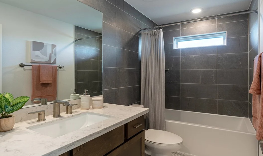 8608 Turaco Trail Austin, TX 78744 - Photo 15 of 20 a bathroom with a sink a toilet and shower
