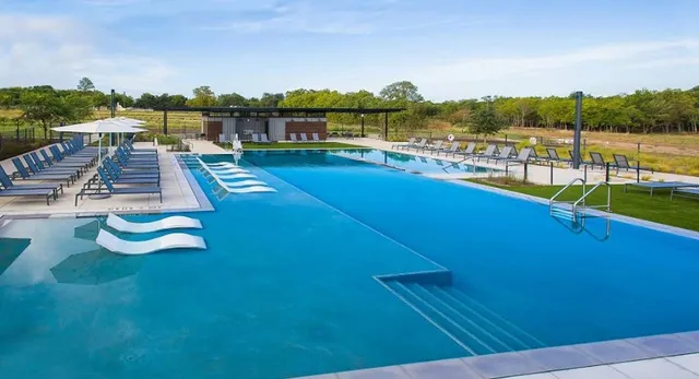 a bathroom with a sink a potted plant and a mirror