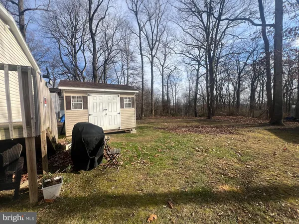 a backyard of a house with barbeque oven