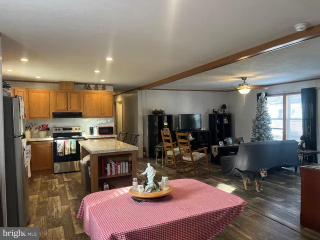 a kitchen with a sink appliances and chairs