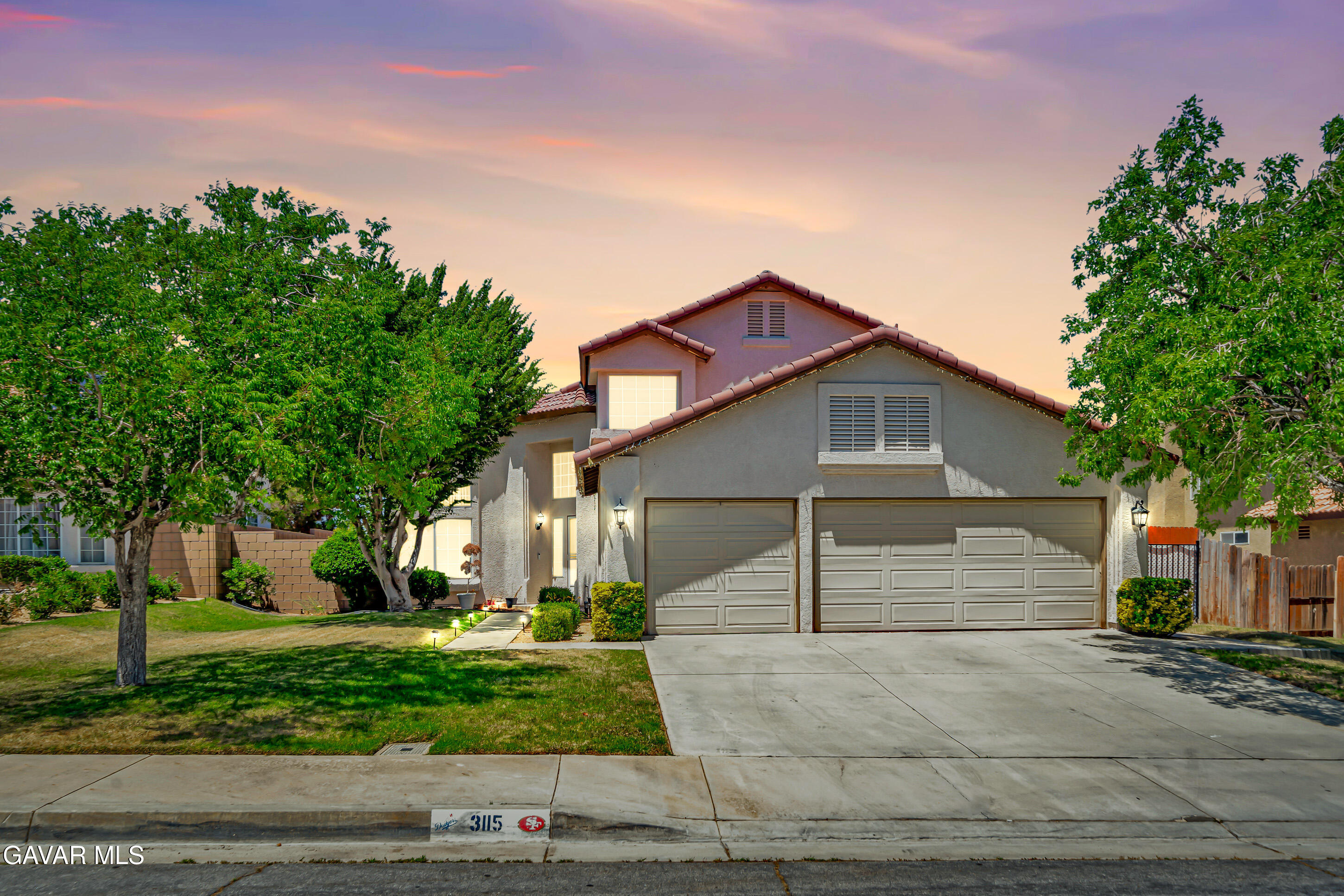 3115 Crowne Drive Palmdale, CA 93551 - Photo 1 of 51 a front view of a house with a garden
