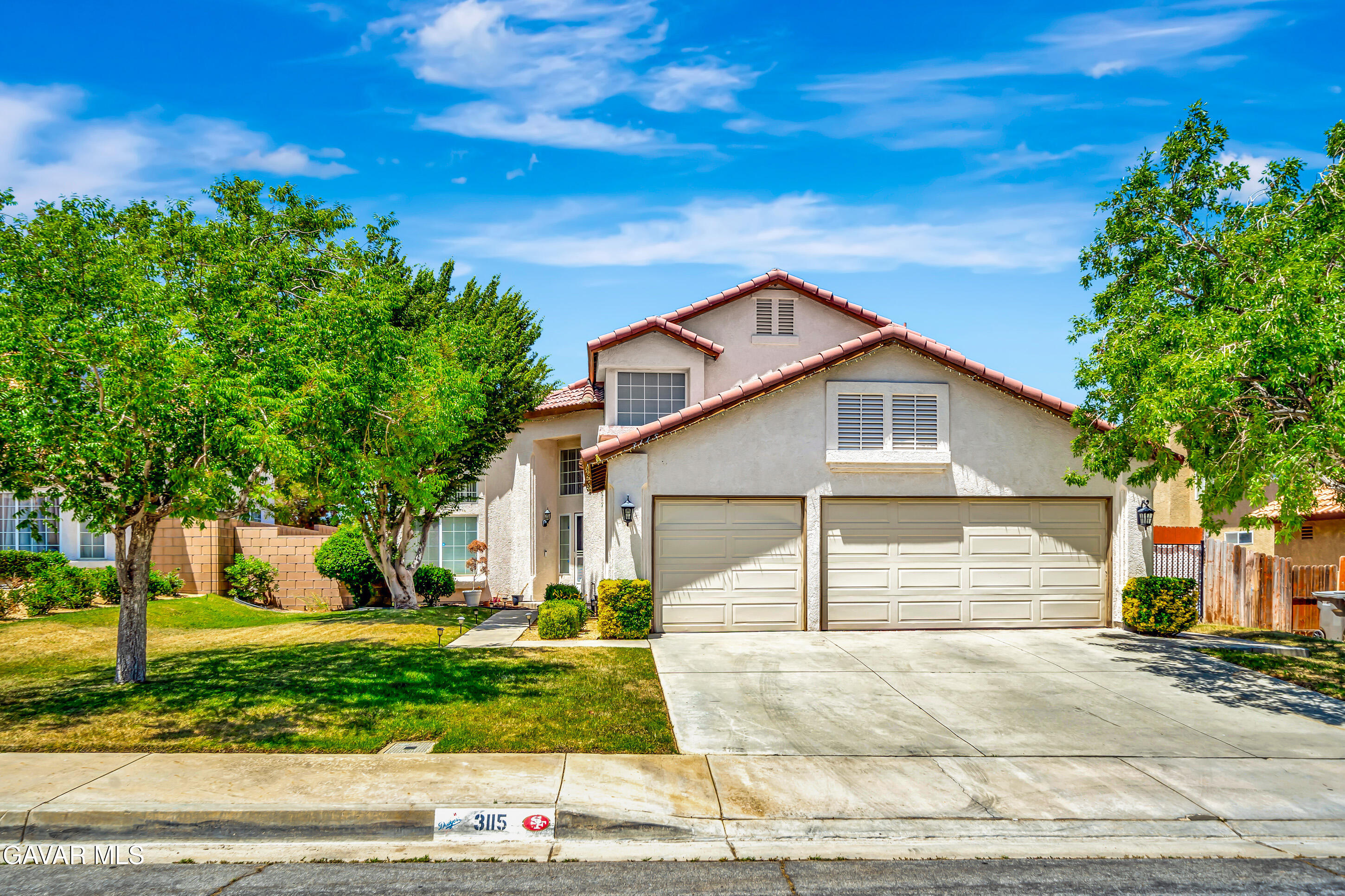 3115 Crowne Drive Palmdale, CA 93551 - Photo 2 of 51 a front view of a house with a yard