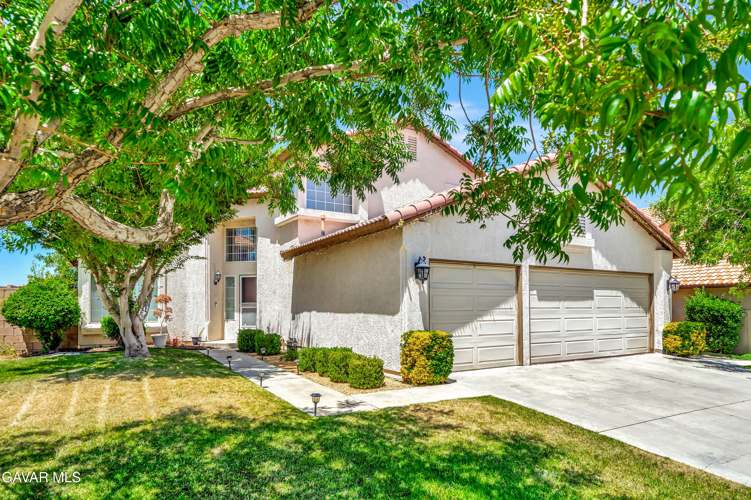 3115 Crowne Drive Palmdale, CA 93551 - Photo 3 of 51 a front view of a house with a yard and garage