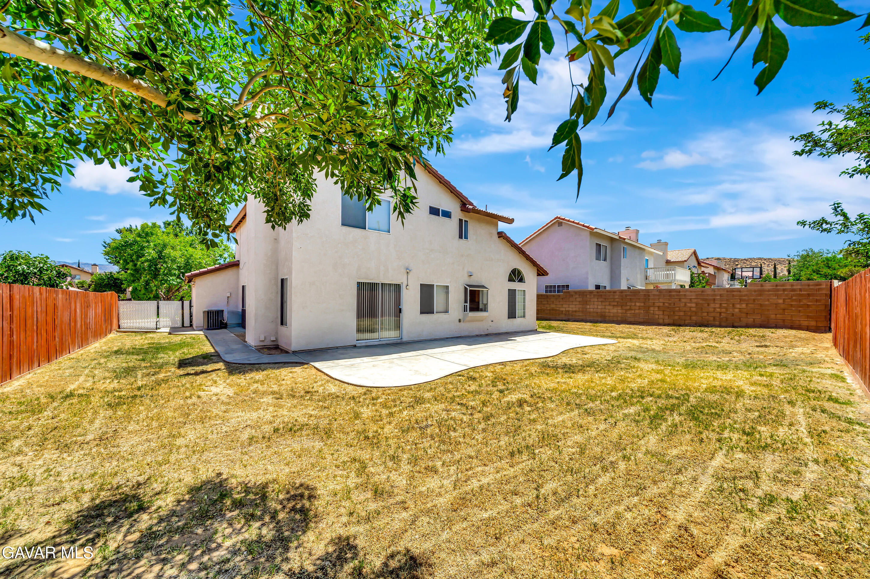 3115 Crowne Drive Palmdale, CA 93551 - Photo 31 of 51 a view of a white house with a yard