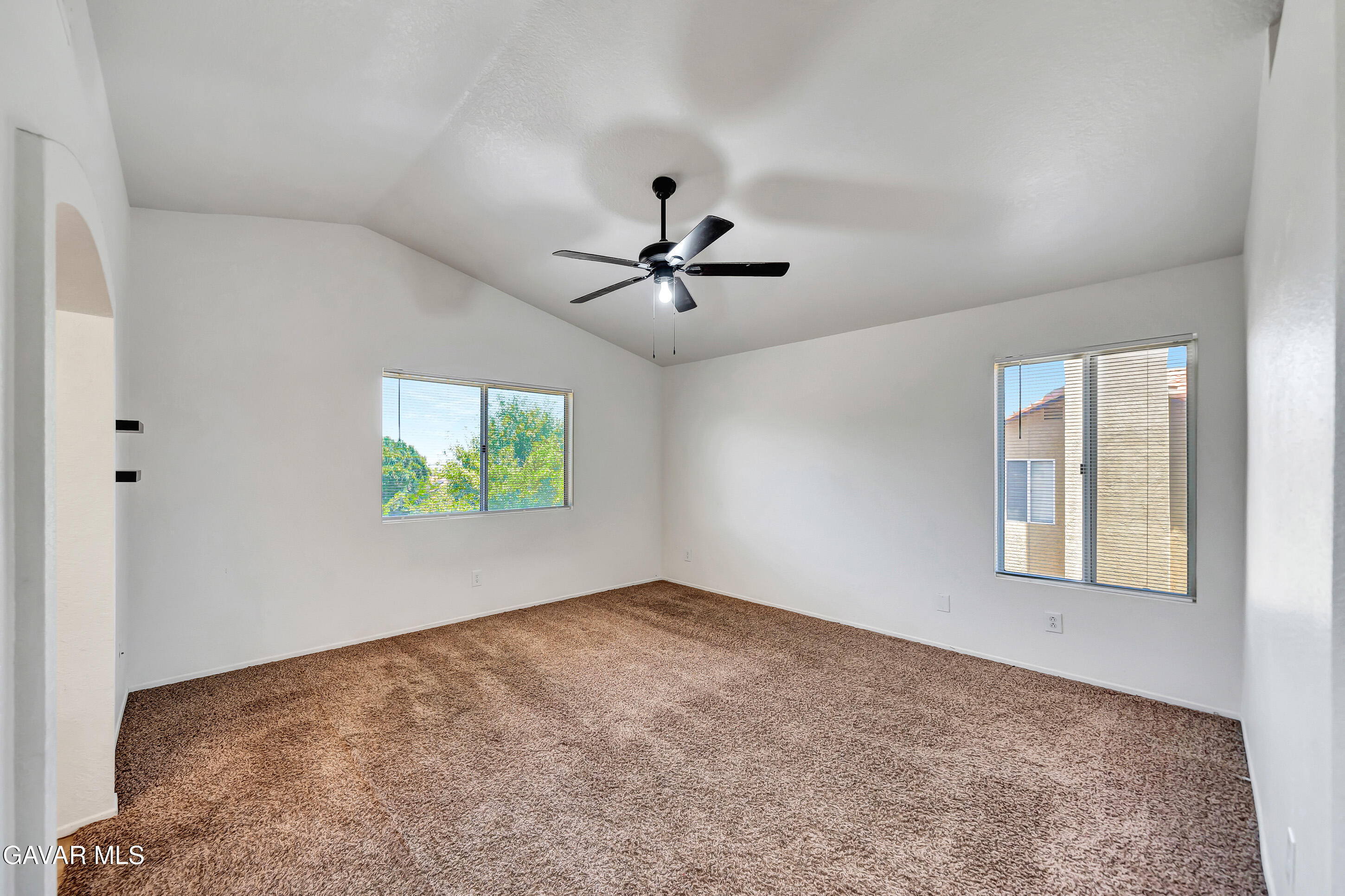 3115 Crowne Drive Palmdale, CA 93551 - Photo 40 of 51 an empty room with windows and ceiling fan