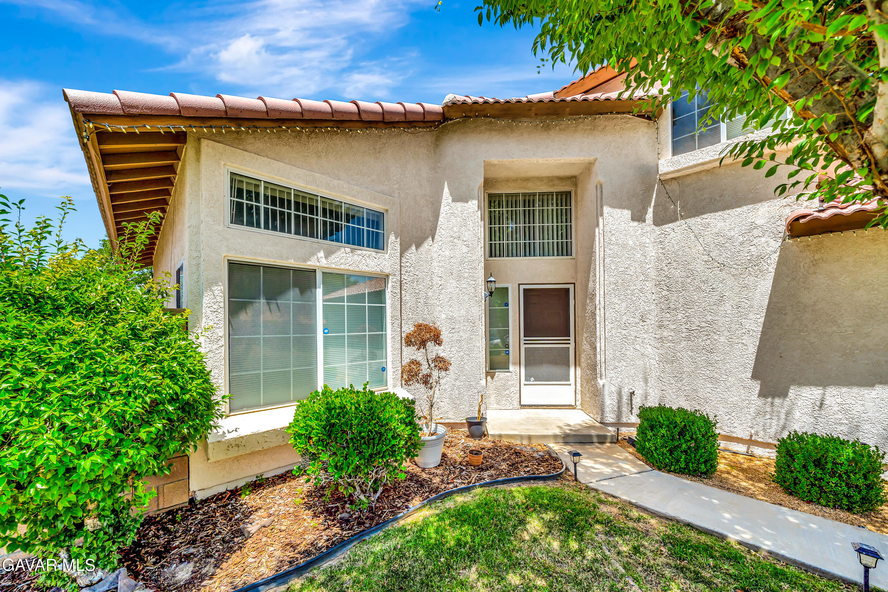 3115 Crowne Drive Palmdale, CA 93551 - Photo 4 of 51 a front view of a house with garden