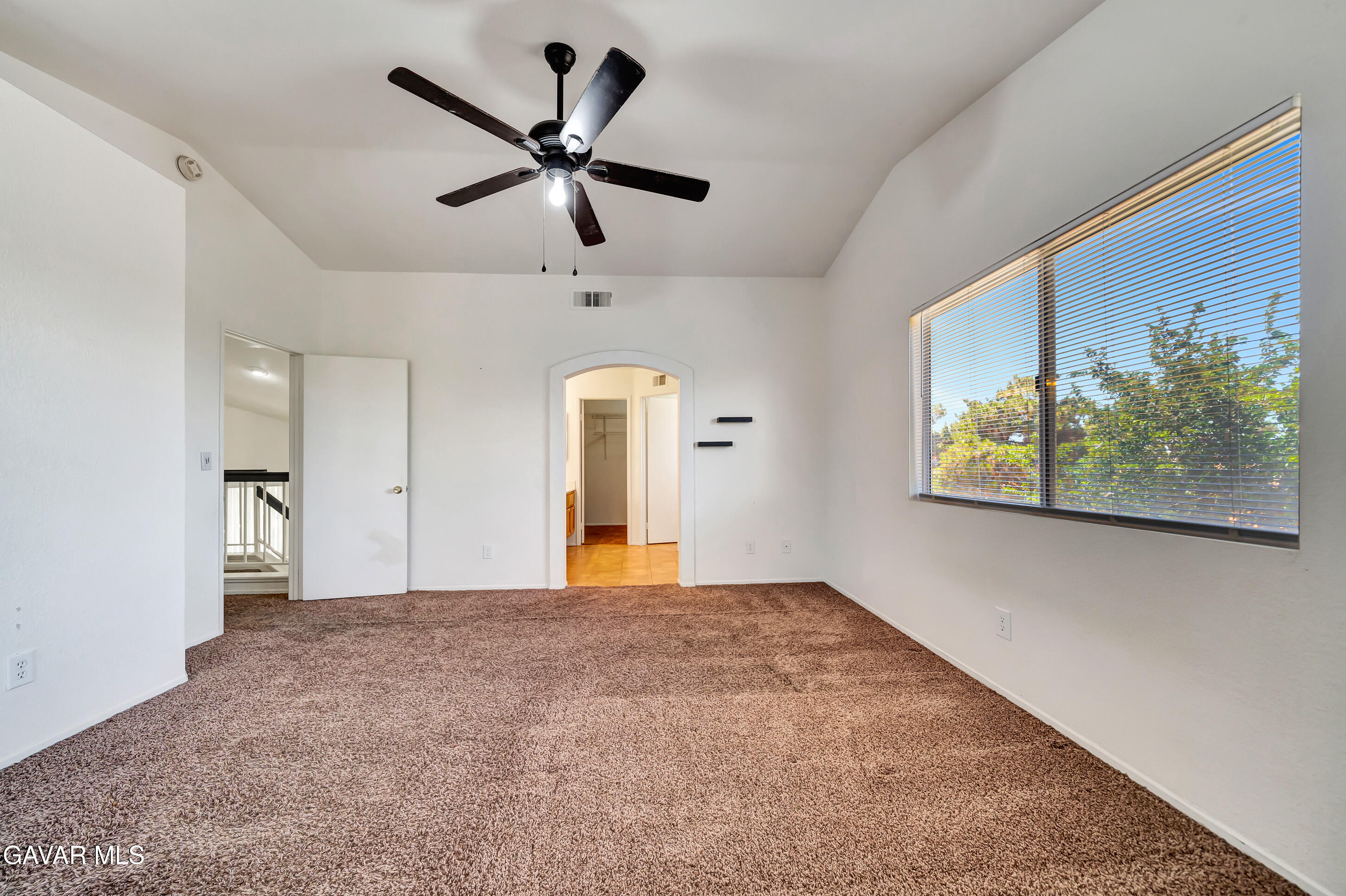 3115 Crowne Drive Palmdale, CA 93551 - Photo 41 of 51 an empty room with window and ceiling fan