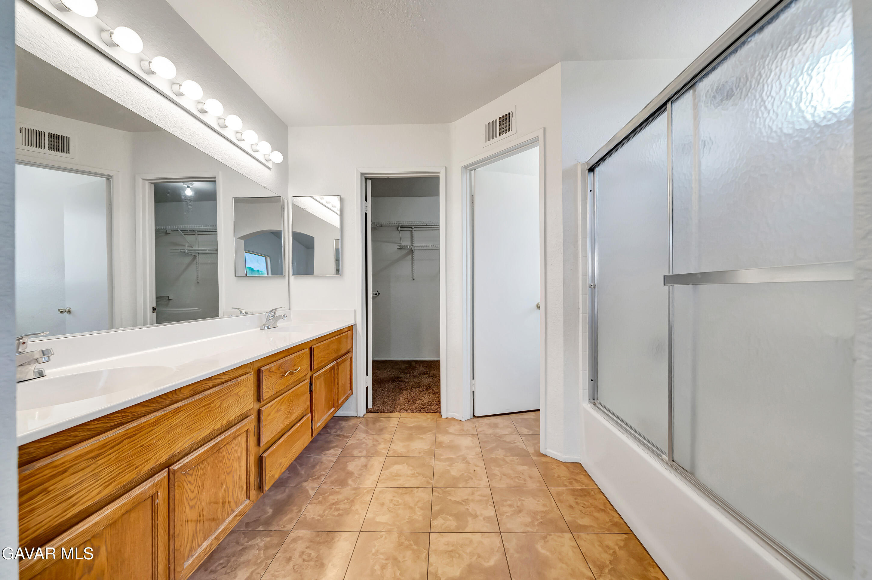 3115 Crowne Drive Palmdale, CA 93551 - Photo 43 of 51 a large en suite bathroom with a large mirror and a shower