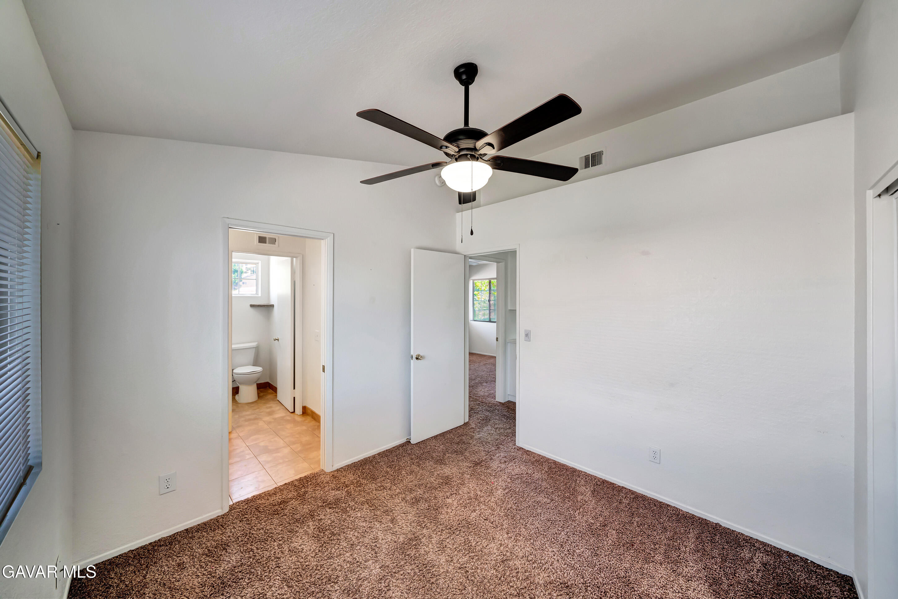 3115 Crowne Drive Palmdale, CA 93551 - Photo 47 of 51 a view of a livingroom with a ceiling fan and a bathroom