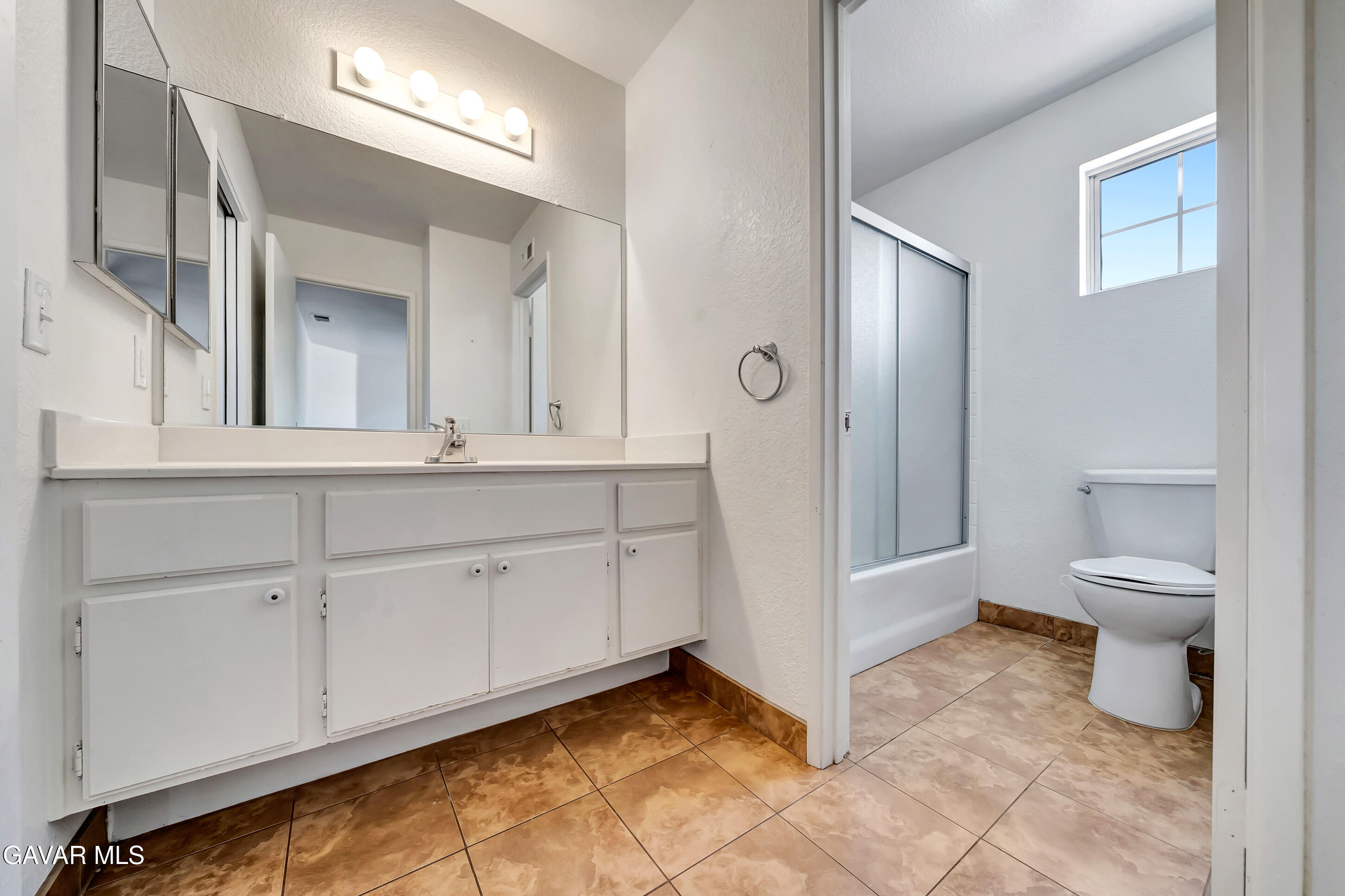 3115 Crowne Drive Palmdale, CA 93551 - Photo 49 of 51 a spacious bathroom with a toilet sink and a mirror