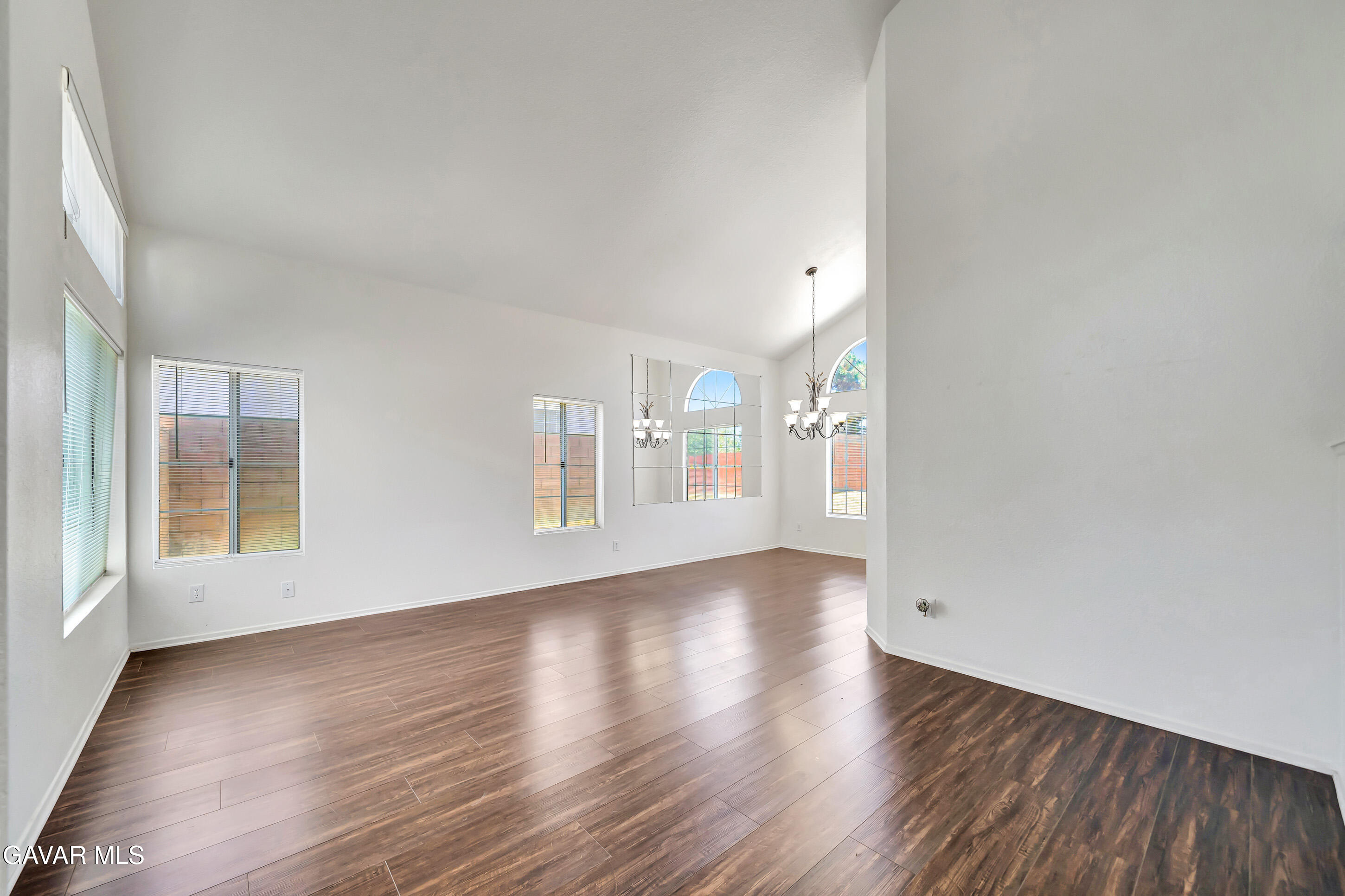 3115 Crowne Drive Palmdale, CA 93551 - Photo 7 of 51 a view of an empty room with wooden floor and a window