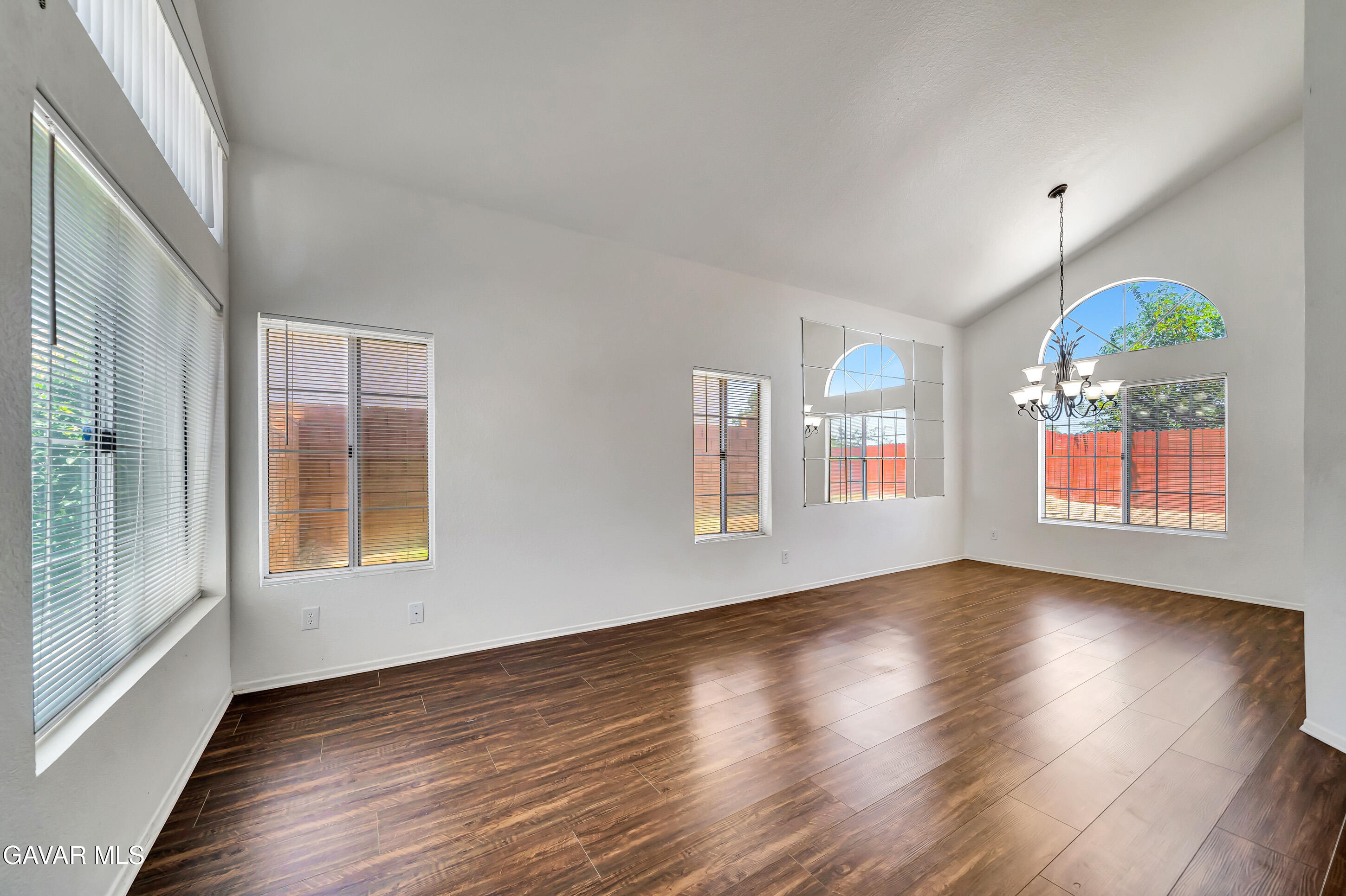3115 Crowne Drive Palmdale, CA 93551 - Photo 8 of 51 a view of an empty room with window and wooden floor