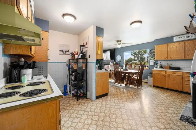 a kitchen with stainless steel appliances a refrigerator sink and cabinets