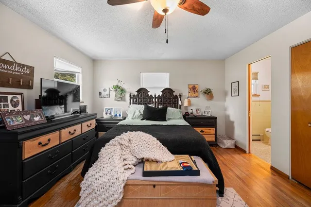 a bedroom with furniture and wooden floor