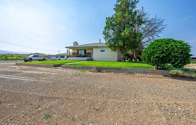 a front view of a house with a yard and trees