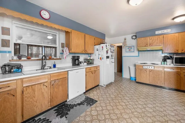 a kitchen with stainless steel appliances a refrigerator sink and cabinets