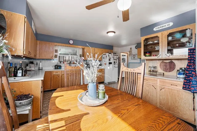 a kitchen with stainless steel appliances wooden floor dining table and chairs