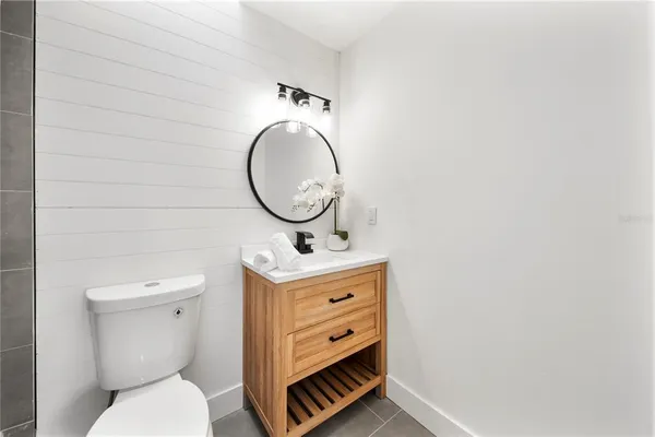 a bathroom with a toilet a sink and a mirror
