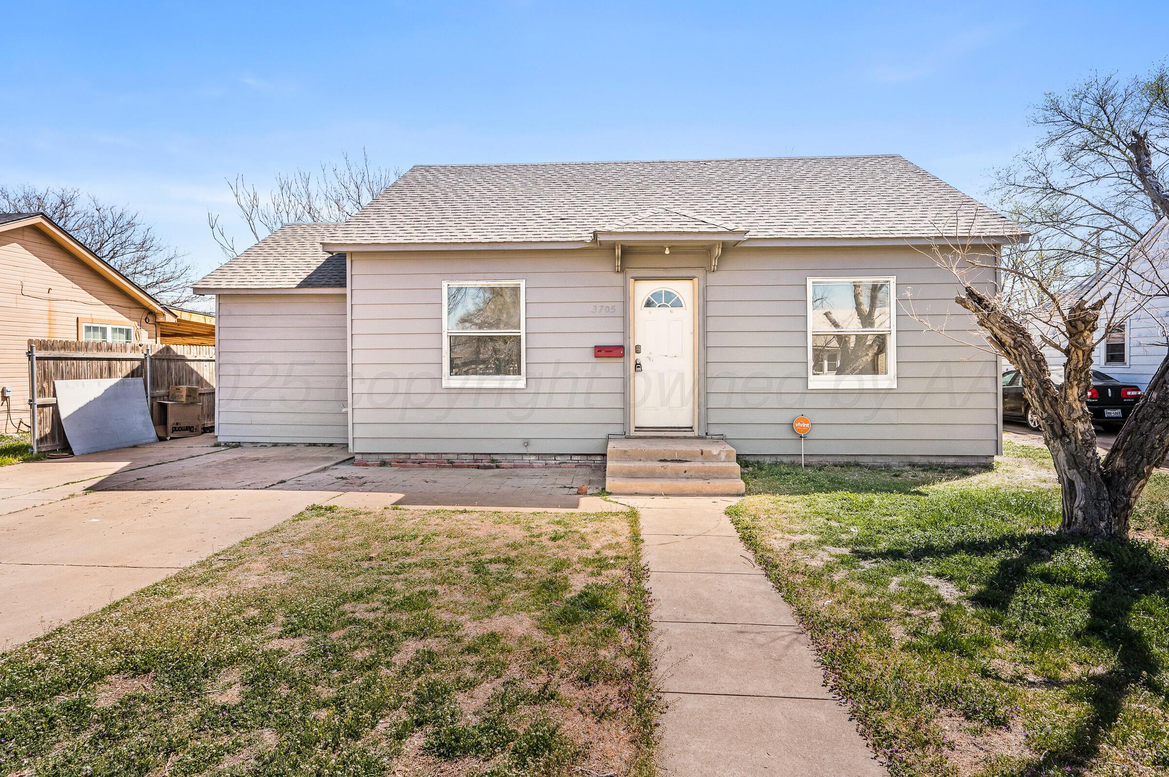 3705 South Polk Street Amarillo, TX 79110 - Photo 1 of 16 a front view of a house with a yard and garage