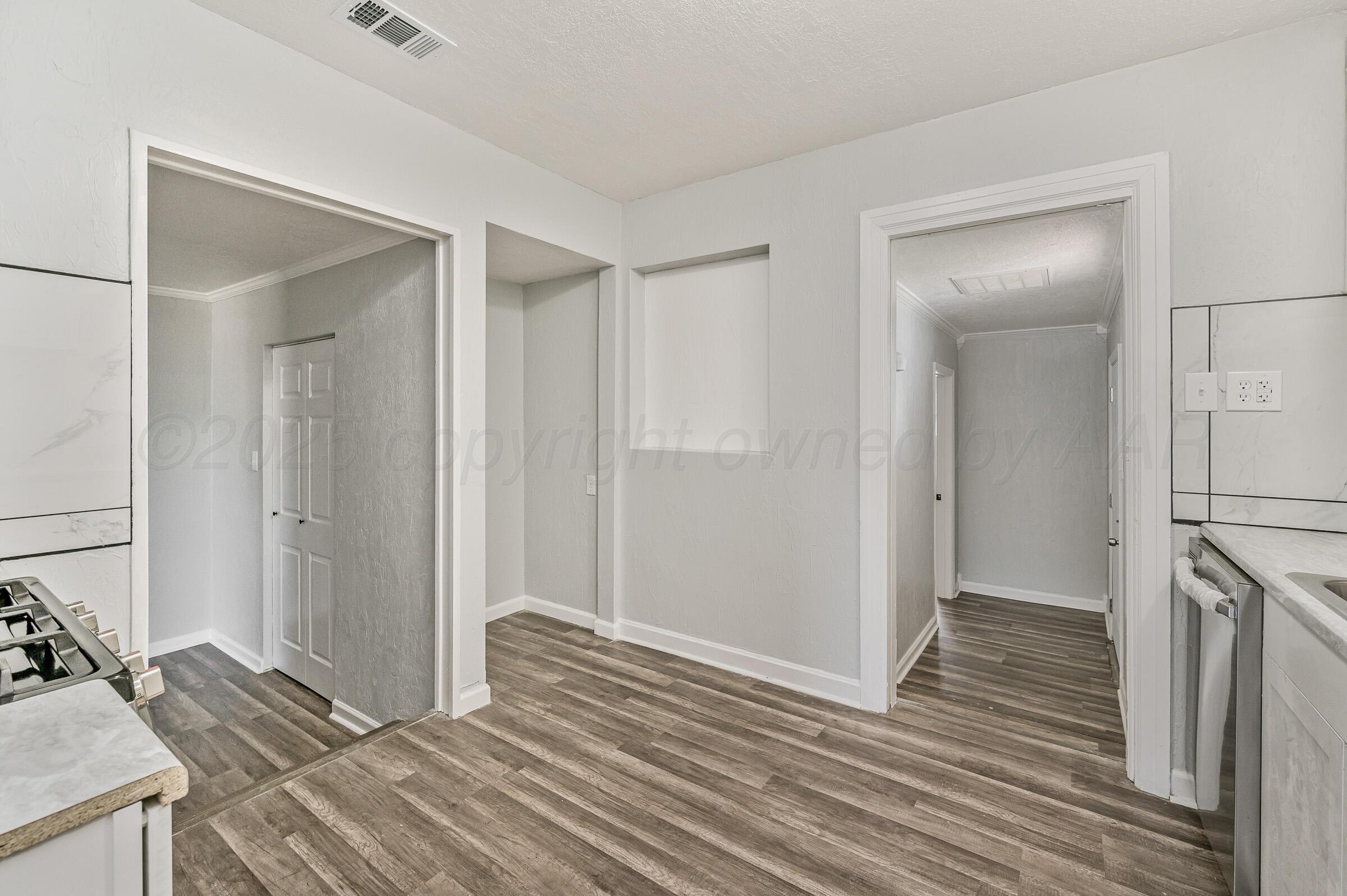 3705 South Polk Street Amarillo, TX 79110 - Photo 11 of 16 a view of a livingroom with wooden floor and a bathroom