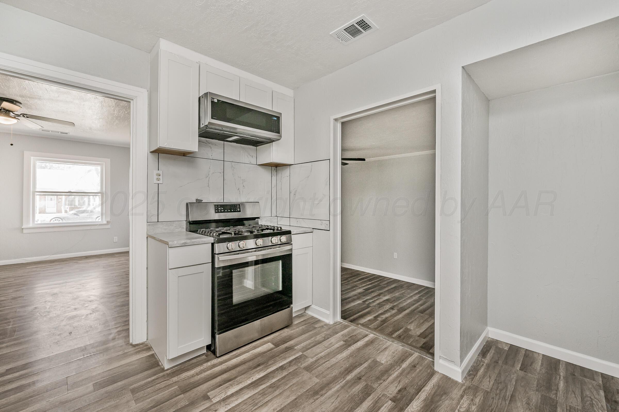 3705 South Polk Street Amarillo, TX 79110 - Photo 12 of 16 a kitchen with a stove and a refrigerator