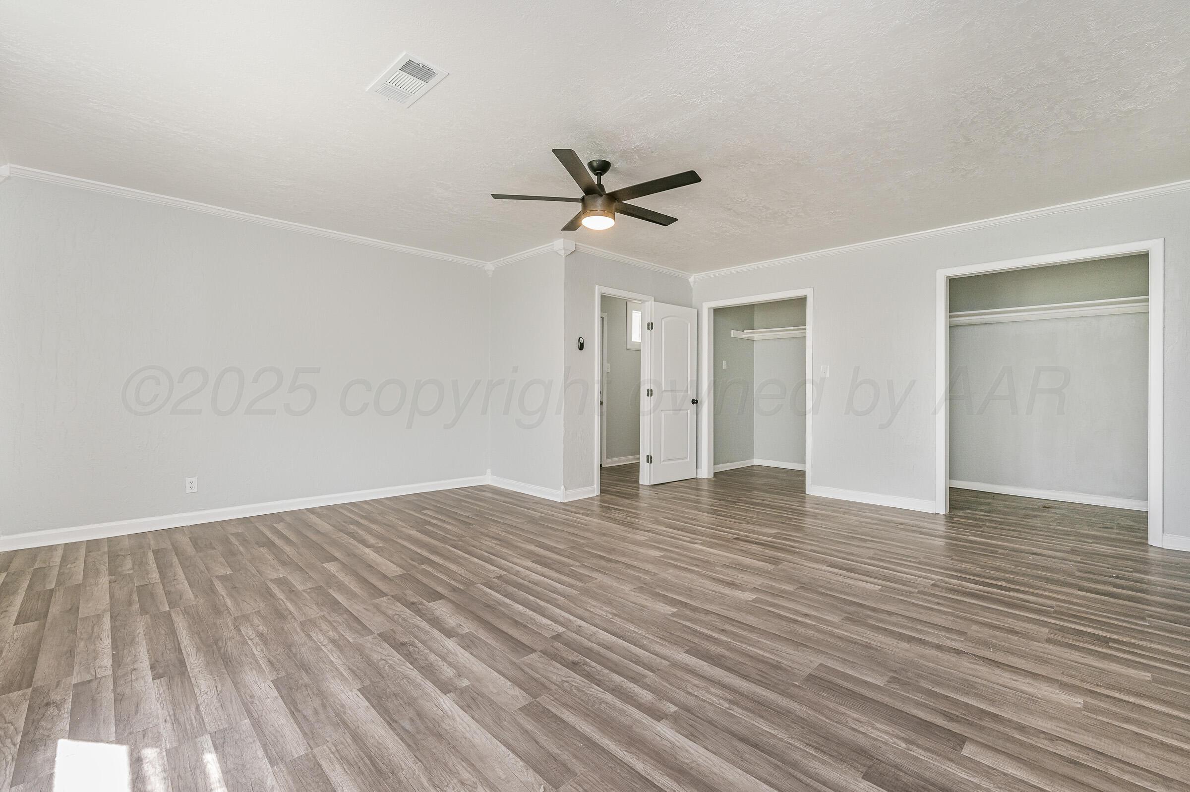 3705 South Polk Street Amarillo, TX 79110 - Photo 6 of 16 wooden floor in an empty room with a window