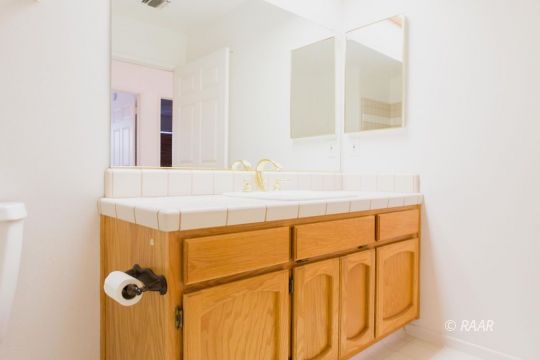 905 Harriet Street Ridgecrest, CA 93555 - Photo 27 of 34 a bathroom with a sink and a mirror