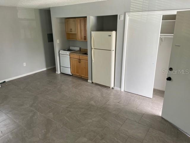 675 Indian Rocks Road North, Unit 209A Belleair Bluffs, FL 33770 - Photo 4 of 7 a view of kitchen with refrigerator and cabinet
