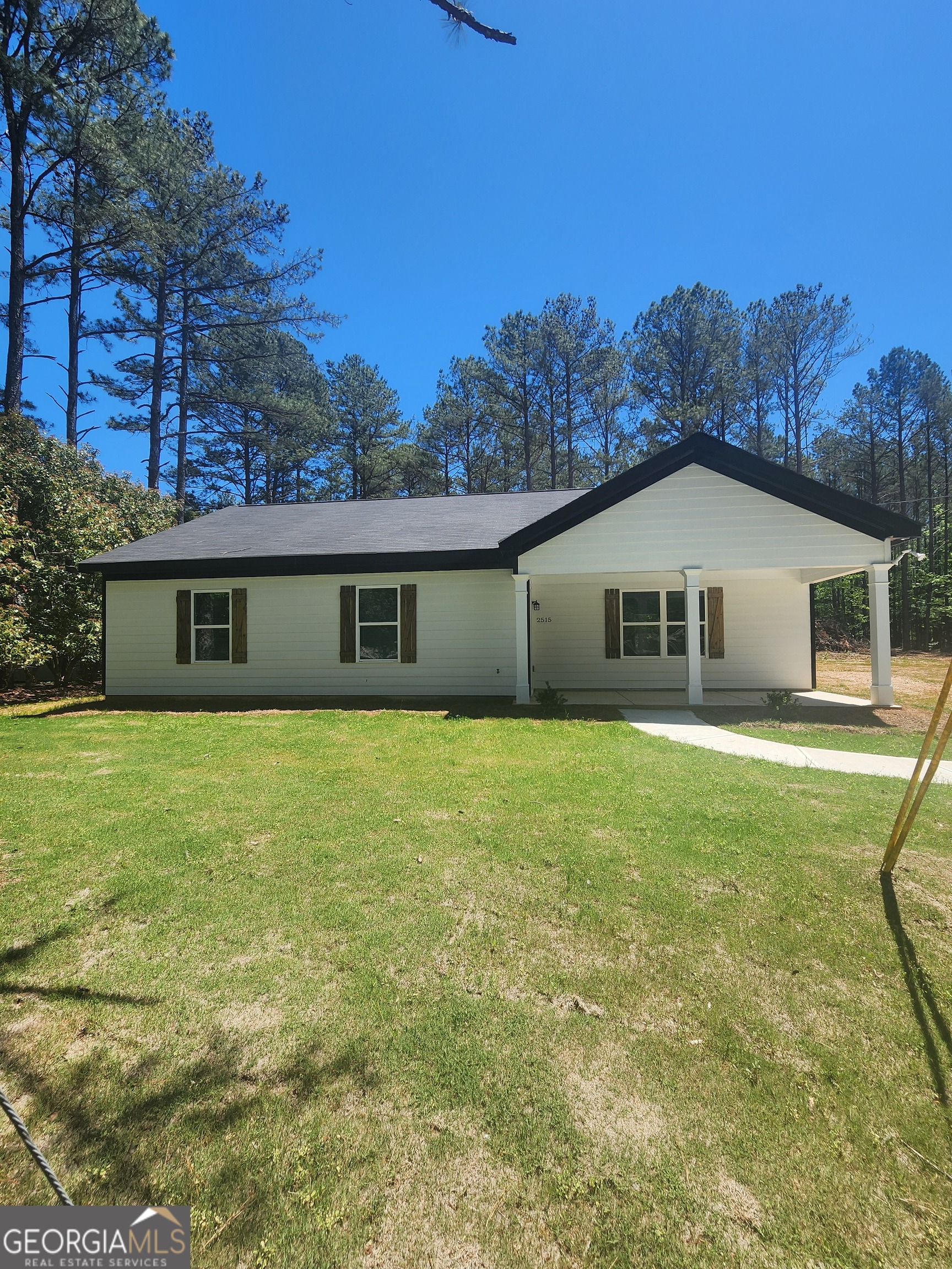 2515 Cleveland Road Bogart, GA 30622 - Photo 1 of 1 a front view of a house with a garden