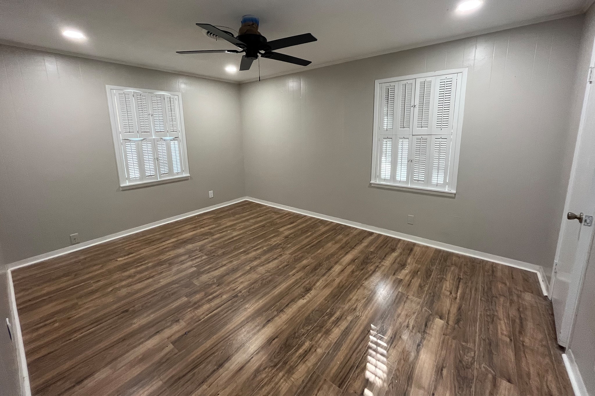 1409 20th Street Huntsville, TX 77340 - Photo 4 of 9 a view of an empty room with a window and wooden floor