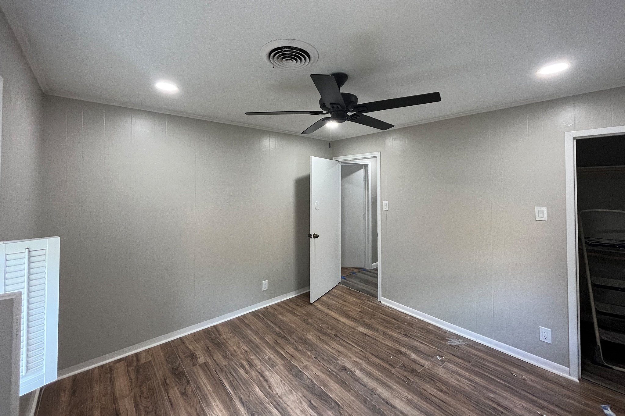 1409 20th Street Huntsville, TX 77340 - Photo 7 of 9 a view of a hallway with a chandelier fan and wooden floor
