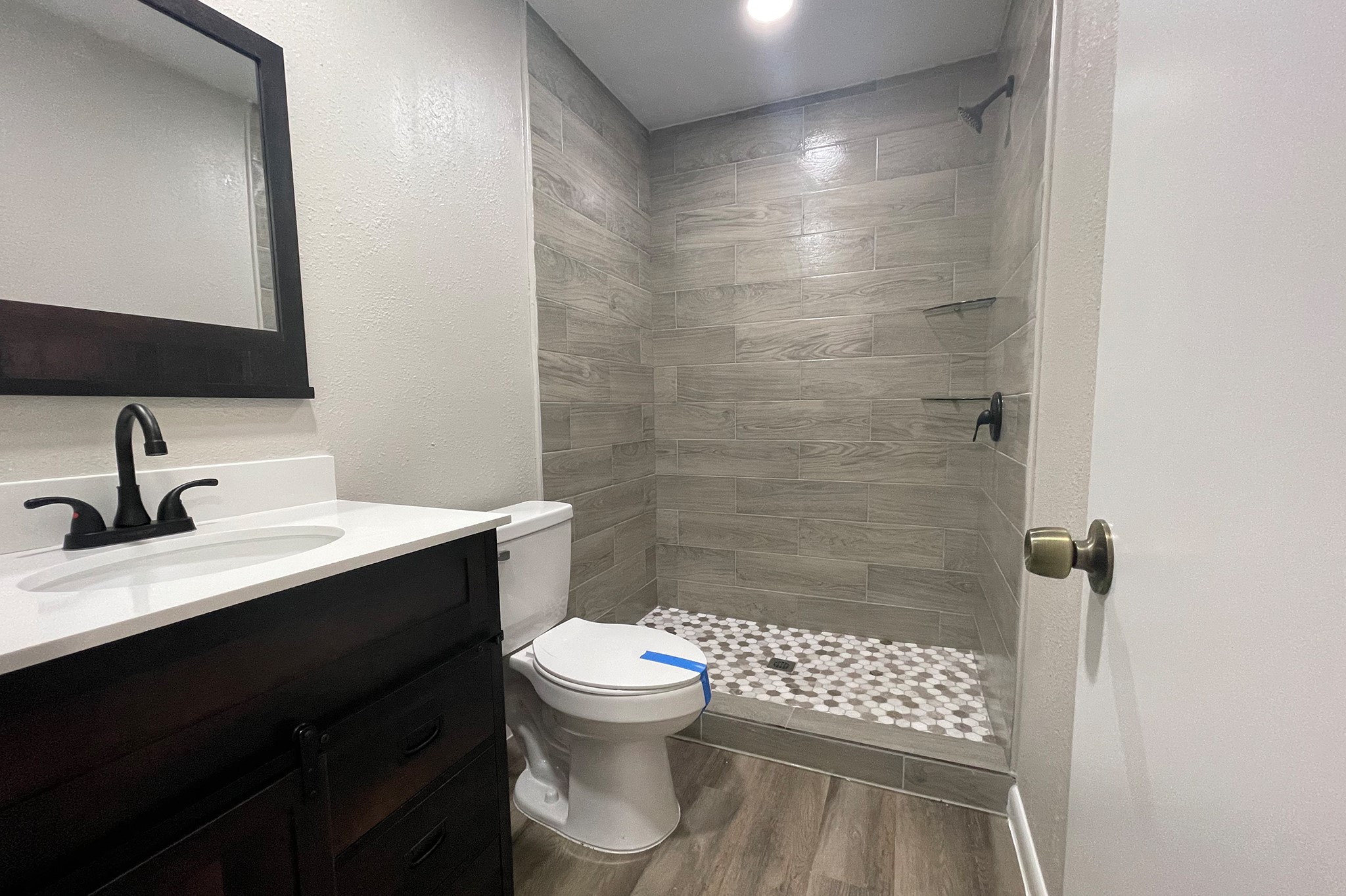 1409 20th Street Huntsville, TX 77340 - Photo 8 of 9 a bathroom with a sink toilet and shower