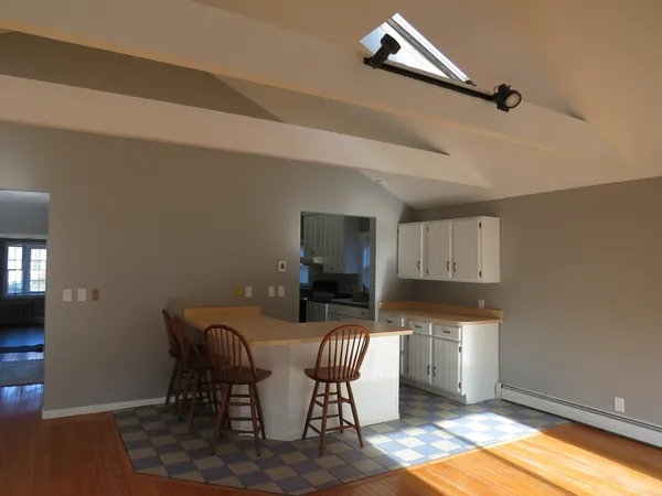 a dining room with furniture and a window
